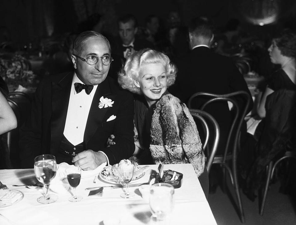 MGM chief Louis B. Mayer dines with one of his stars, Jean Harlow, in 1933. (Photo: Bettmann/Getty Images)