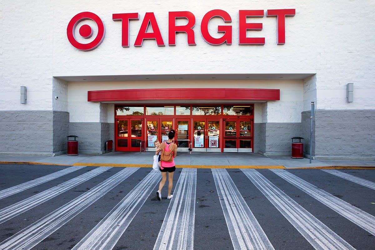 A woman carriers her child into Target.