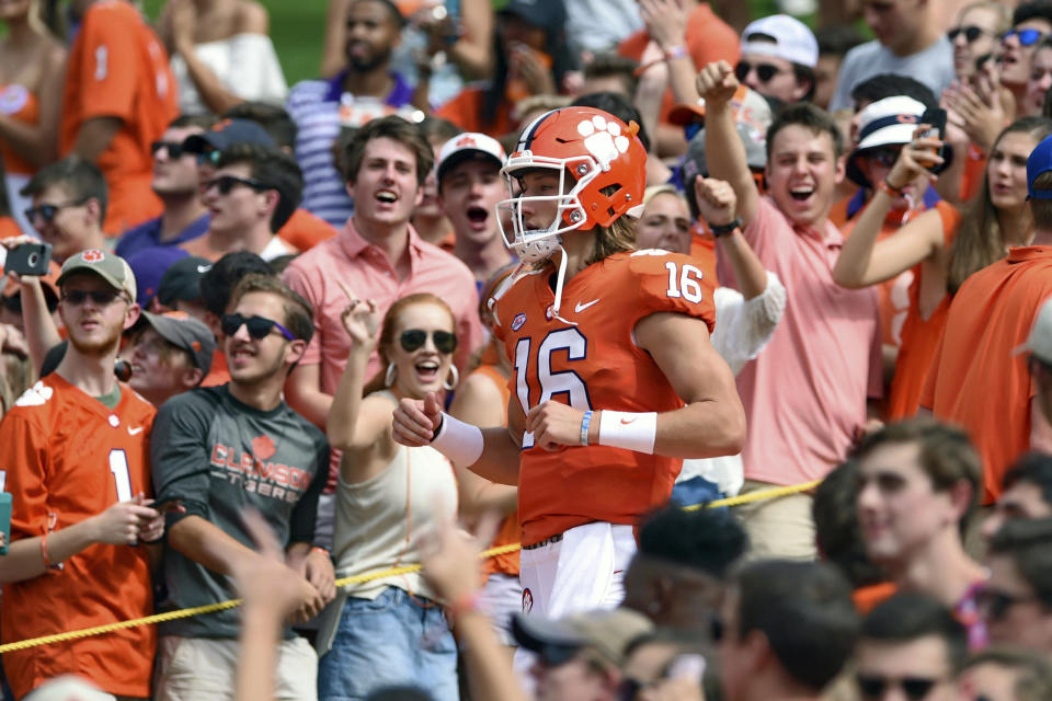 FILE - In this Sept. 29, 2018, file photo, Clemson quarterback Trevor Lawrence runs down "The Hill" before the start of an NCAA college football game against Syracuse, in Clemson, S.C. For the first time, the defending national champion Tigers are No. 1 in The Associated Press preseason Top 25 presented by Regions Bank, Monday, Aug. 19, 2019. Clemson won its second national title in three seasons behind freshman quarterback Trevor Lawrence to claim equal standing with Alabama at the top of the sport. (AP Photo/Richard Shiro, File)