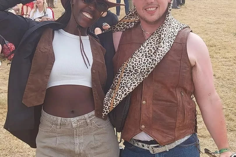 Two people standing side by side at Glastonbury Festival