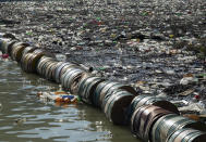 Plastic bottles, wooden planks, rusty barrels and other garbage clogging the Drina river near the eastern Bosnian town of Visegrad, Bosnia, Tuesday, Jan. 5, 2021. Further upstream, the Drina tributaries in Montenegro, Serbia and Bosnia are carrying even more waste after the swollen rivers surged over the the landfills by their banks. The Balkan nations have poor waste management and tons of garbage routinely end up in rivers. (AP Photo/Eldar Emric)