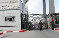 Hamas security officers stand guard the gate of the border to the Egyptian side of Rafah crossing, in Rafah, Gaza Strip, Tuesday, Aug. 11, 2020. Egypt reopened Rafah Crossing for three days starting Tuesday for humanitarian cases in and out of the Gaza Strip, including medical patients and people who had Egyptian and international citizenship. The border was closed since March. (AP Photo/Adel Hana)