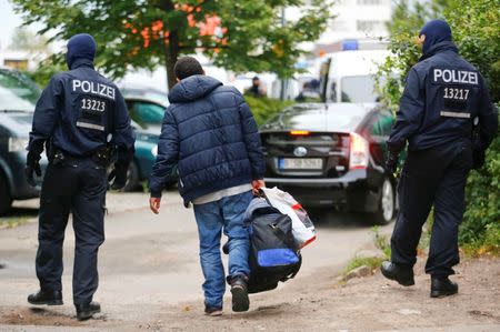 German special police members walk near a mosque association property in Berlin, Germany September 22, 2015. REUTERS/Hannibal Hanschke