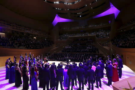 About 1000 high school students sing "Purple Rain" to honor the late singer Prince at Walt Disney Concert Hall which is illuminated purple in Downtown Los Angeles, U.S., April 22, 2016. REUTERS/Mario Anzuoni