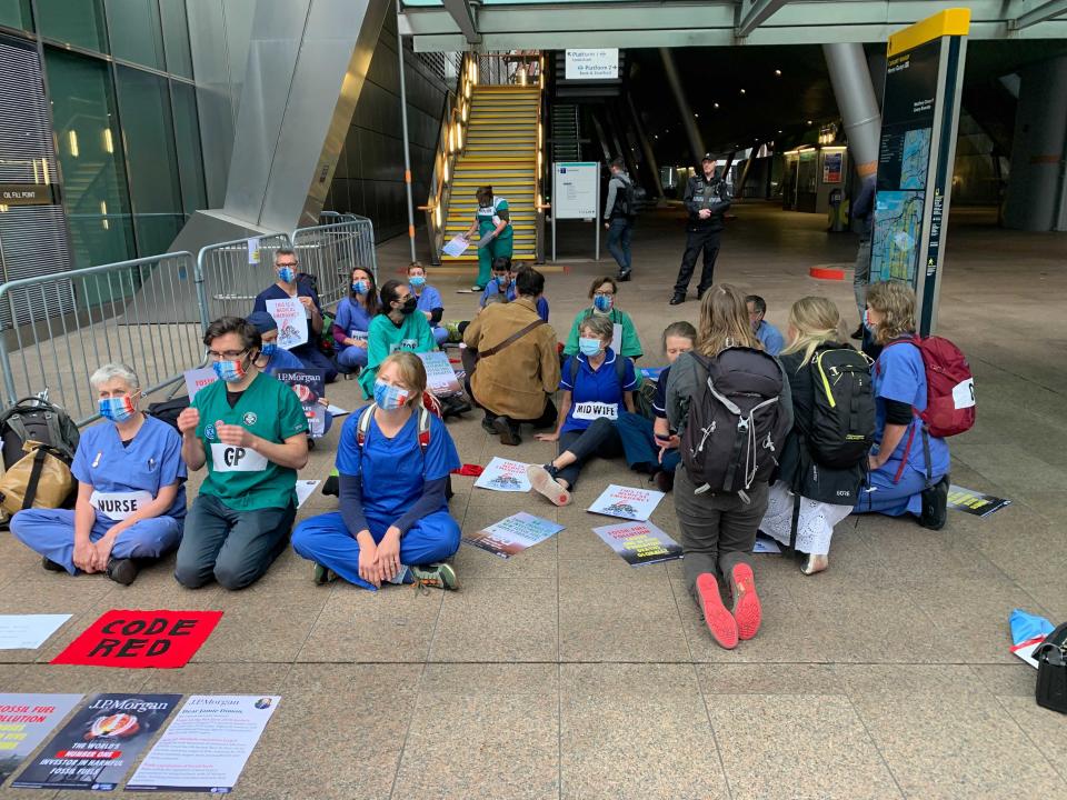 Protesters gathered outside a DLR station close to the bank’s HQ (The Independent)