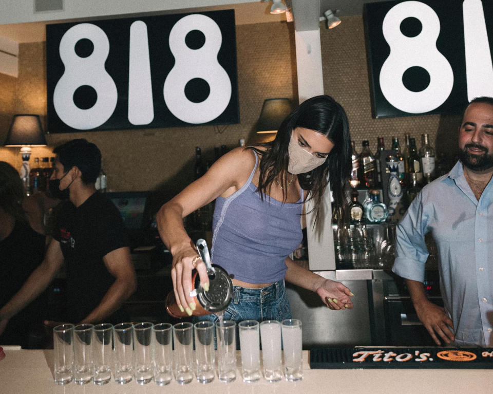 <p>Kendall Jenner gets into the partying spirt by pouring shots of her 818 Tequila to restaurant guests in Southhampton on Aug. 16.</p>