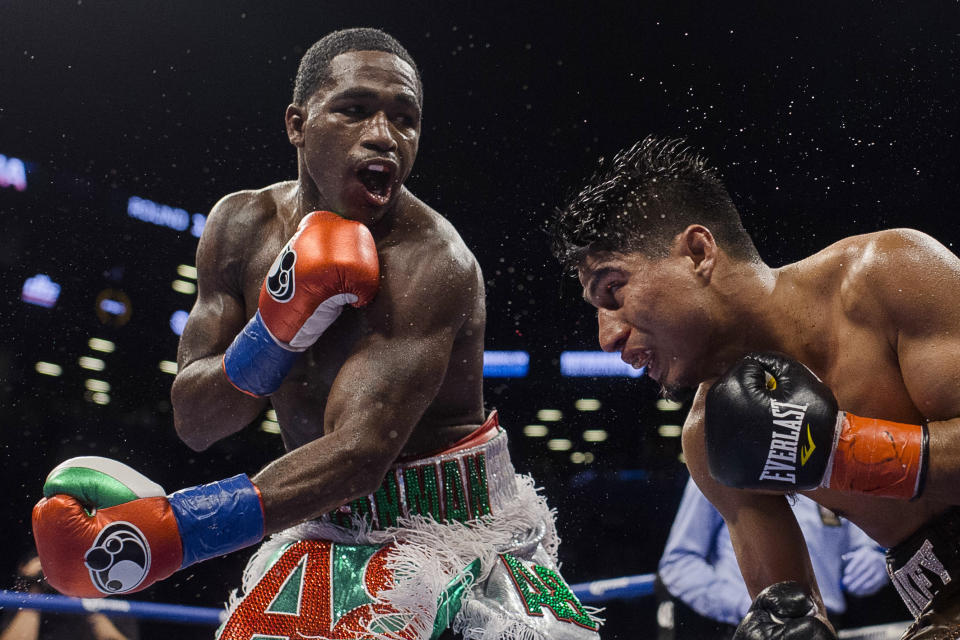 Adrien Broner (L) follows through on a punch to Mikey Garcia during a boxing bout at 140 pounds, Saturday, July 29, 2017, in New York. (AP Photo/Andres Kudacki)