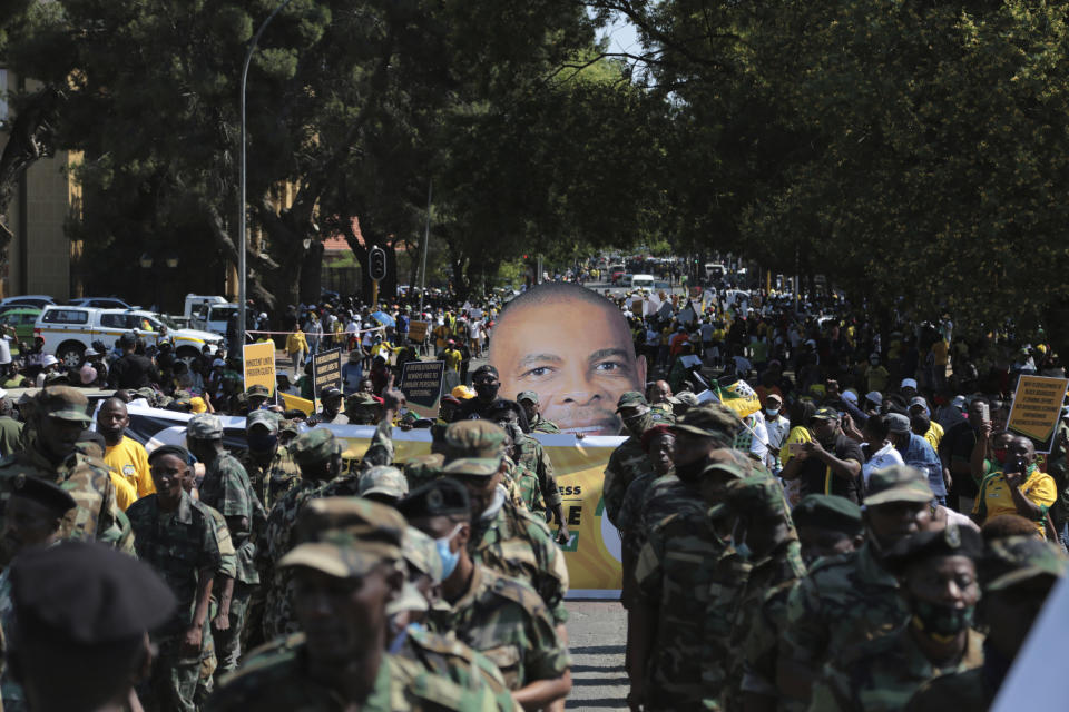 Supporters for African National Congress secretary general Ace Magashule protest outside the magistrates court during a bail hearing for Magashulein Bloemfontein, South Africa, Friday, Nov. 13, 2020. Magashule is charged in connection with the looting of $13.8 million when he was premier of the Free State province from 2009 until 2018. (AP Photo)