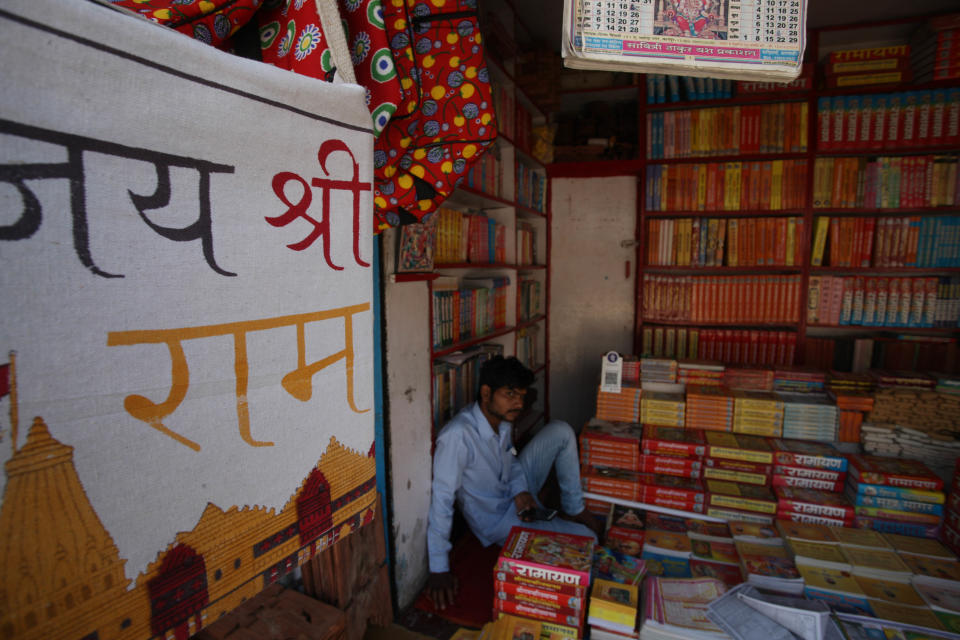 A shop keeper sits inside his book shop near Hanuman Garhi Temple before the arrival of Prime Minister Narendra Modi for Gournd breaking ceremony of Ram Temple ,during the Covid 19 pandemic, in Ayodhya, India on August 4, 2020. (Photo by Ritesh Shukla/NurPhoto via Getty Images)