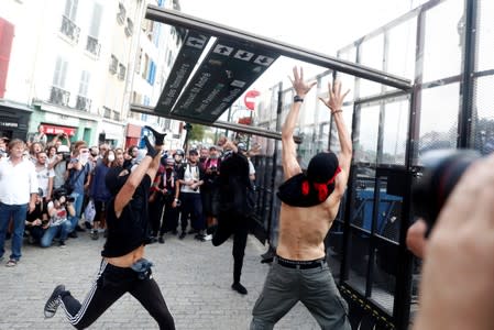 Demonstrators use a part of a barricade to attack the police blockade during a protest against G7 summit, in Bayonne