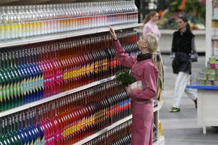 A model presents a creation by German designer Karl Lagerfeld as part of his Fall/Winter 2014-2015 women's ready-to-wear collection for French fashion house Chanel at the Grand Palais transformed into a "Chanel Shopping Center" during Paris Fashion Week March 4, 2014. REUTERS/Benoit Tessier