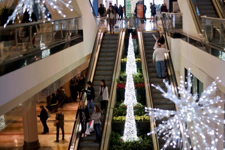 Shoppers ascend and descend an escalator at the King of Prussia Mall, United States' largest retail shopping space, in King of Prussia