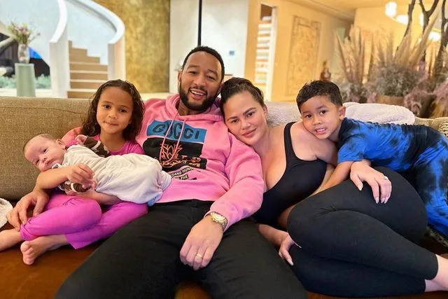 Chrissy Teigen Instagram Chrissy Teigen and John Legend pose with their three kids: Luna, Miles and Esti