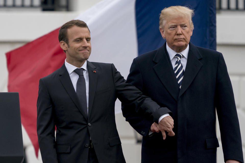 FILE – Then-U.S. President Donald Trump and French President Emmanuel Macron hold hands during a ceremony at the White House in Washington, Tuesday, April 24, 2018. As chances rise of a Joe Biden-Trump rematch in the U.S. presidential election race, America’s allies are bracing for a bumpy ride, with concerns rising that the U.S. could grow less dependable regardless of who wins. (AP Photo/Andrew Harnik, File)