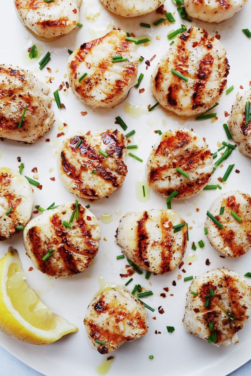 <p>Scallops will make you feel fancy no matter what—and they're so easy to grill. When seasoned with some salt, pepper, and chilli flakes, they're pure gold. </p><p>Get the <a href="https://www.delish.com/uk/cooking/recipes/a32821279/best-grilled-scallops-recipe/" rel="nofollow noopener" target="_blank" data-ylk="slk:Grilled Scallops;elm:context_link;itc:0;sec:content-canvas" class="link ">Grilled Scallops</a> recipe.</p>