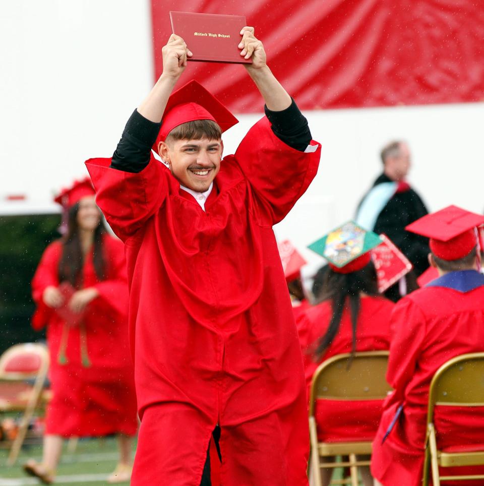 Nicholas Miranda Ribeiro is all smiles after receiving his diploma during Milford High graduation ceremonies, June 4, 2023.    