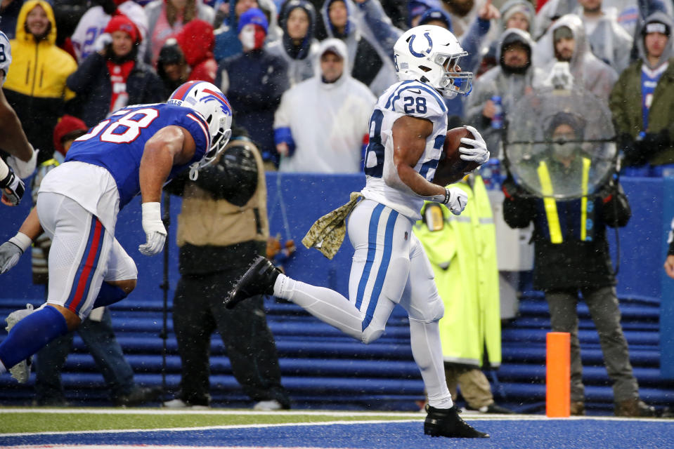 Indianapolis Colts running back Jonathan Taylor (28) scores past Buffalo Bills outside linebacker Matt Milano (58) during the second half of an NFL football game in Orchard Park, N.Y., Sunday, Nov. 21, 2021. (AP Photo/Jeffrey T. Barnes)