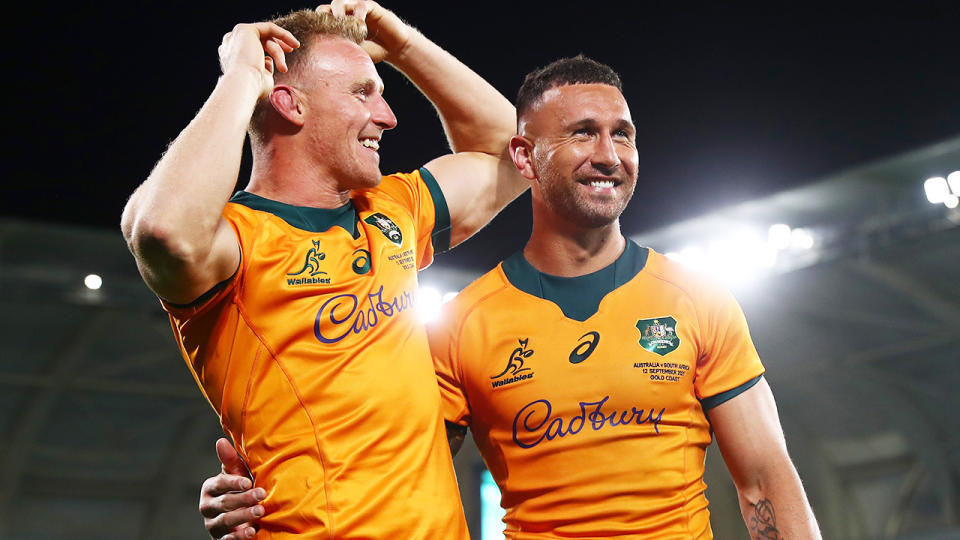 Wallabies duo Reece Hodge and Quade Cooper celebrate after Cooper's match-winning penalty against South Africa.