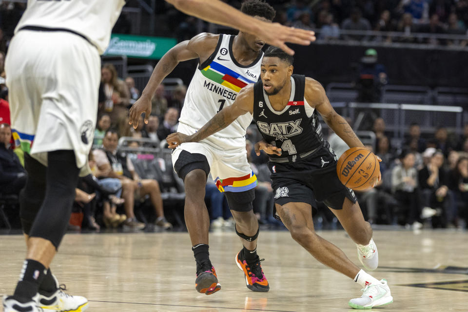 San Antonio Spurs guard Blake Wesley (14) drives past Minnesota Timberwolves guard Anthony Edwards (1) during the second half of an NBA basketball game, Saturday, April 8, 2023, in Austin, Texas. (AP Photo/Stephen Spillman)