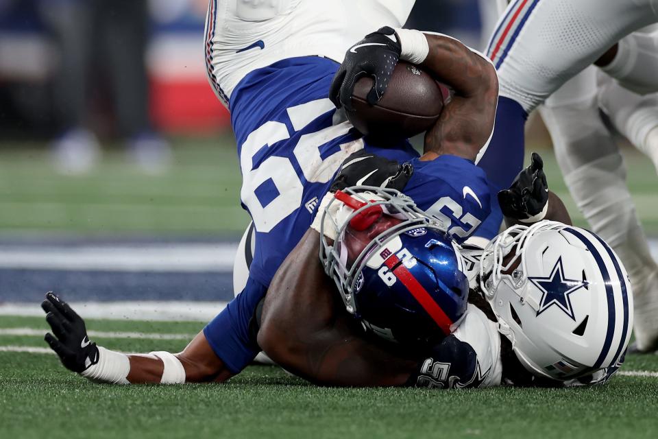 EAST RUTHERFORD, NEW JERSEY – SEPTEMBER 26: Tyrone Tracy Jr. #29 of the New York Giants is tackled by Mazi Smith #58 of the Dallas Cowboys in the second quarter at MetLife Stadium on September 26, 2024 in East Rutherford, New Jersey. (Photo by Sarah Stier/Getty Images)