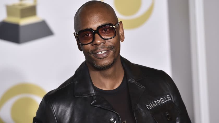 FILE - In this Jan. 28, 2018 file photo, Dave Chappelle poses in the press room with the best comedy album award for "The Age of Spin" and "Deep in the Heart of Texas" at the 60th annual Grammy Awards at Madison Square Garden in New York. Chappelle, Sandra Bullock, Christopher Walken, Rita Moreno and Helen Mirren are among the latest slate of stars set to appear on the 90th Academy Awards. Oscar telecast producers revealed another round of celebrity presenters on Tuesday, Feb. 17, 2018, which also includes Jane Fonda, Matthew McConaughey, Lupita Nyongâ€™o, Nicole Kidman, Jodie Foster, Ashley Judd and Eugenio Derbez.(Photo by Charles Sykes/Invision/AP, File)