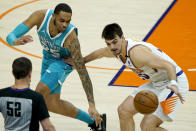 Phoenix Suns forward Frank Kaminsky, right, steals the ball from Charlotte Hornets forward P.J. Washington (25) during the first half of an NBA basketball game, Wednesday, Feb. 24, 2021, in Phoenix. (AP Photo/Matt York)