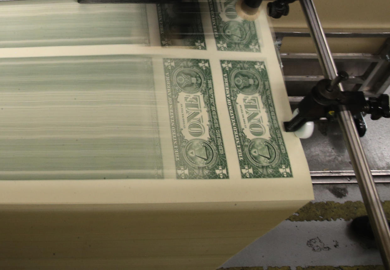 WASHINGTON, DC - MARCH 24:  Sheets of one dollar bills run through the printing press at the Bureau of Engraving and Printing on March 24, 2015  in Washington, DC. The roots of The Bureau of Engraving and Printing can be traced back to 1862, when a single room was used in the basement of the main Treasury building before moving to its current location on 14th Street in 1864. The Washington printing facility has been responsible for printing all of the paper Federal Reserve notes up until 1991 when it shared the printing responsibilities with a new western facility that opened in Fort Worth, Texas.  (Photo by Mark Wilson/Getty Images)