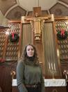 The Rev. Lauren Bennett stands in front of a cross at her church, Metropolitan Community Church of Greater St. Louis, on Jan. 9, 2023, in St. Louis, Mo. Bennett served as spiritual adviser to Missouri inmate Amber McLaughlin and sat next to McLaughlin when she was executed on Jan. 3, 2023, for killing a woman in suburban St. Louis. Spiritual advisers now are commonly with inmates at executions following a ruling last year by the Supreme Court. (AP Photo/Jim Salter)