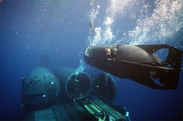 Seal Delivery Vehicle maneuvers into a dry deck shelter on the submarine