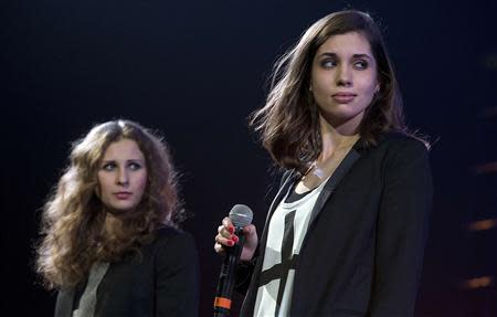 Russian punk band Pussy Riot members Maria Alyokhina (L) and Nadezhda Tolokonnikova speak on stage during Amnesty International's "Bringing Human Rights Home" concert in the Brooklyn borough of New York February 5, 2014. The two members took to a New York stage on Wednesday evening to demand the release of anti-government prisoners as Russia prepares to open the Winter Olympics in Sochi. REUTERS/Carlo Allegri