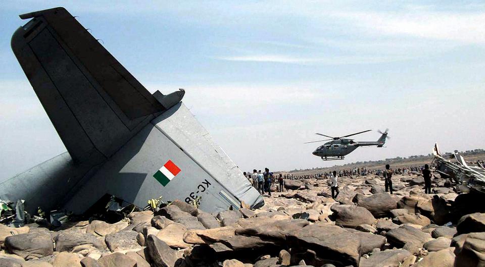 An Indian air force (IAF) helicopter hovers over the site where an IAF cargo plane crashed near Karauli village in the central Indian state of Madhya Pradesh, Friday, March 28, 2014. C-130J Hercules plane inducted into service just last year crashed during a training mission Friday, killing all five crew members in the latest in a series of accidents that have hit the Indian armed forces. (AP Photo)
