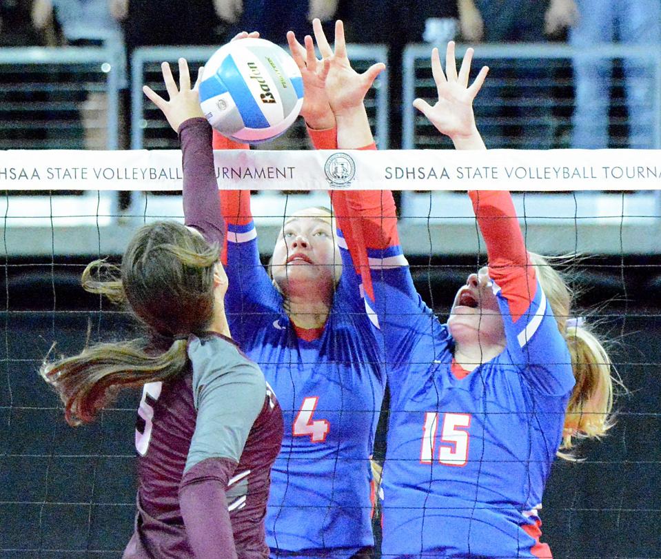 Warner's Ava Nilsson (4) and Kamryn Anderson (15) go up for the block against Freeman's Erin Uecker during their first-round Class B match in the state high school volleyball tournament on Thursday, Nov. 17, 2022 in the Denny Sanford PREMIER Center.