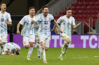 Argentina's Lionel Messi (10) and teammates celebrate defeating Colombia in a penalty shootout during a Copa America semifinal soccer match at the National stadium in Brasilia, Brazil, Wednesday, July 7, 2021. (AP Photo/Andre Penner)