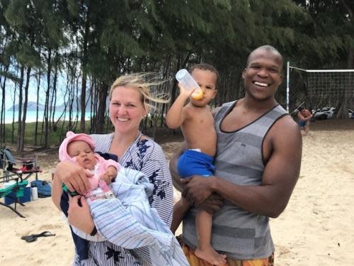 Lindani Myeni on a beach in Hawaii with his wife and two children.