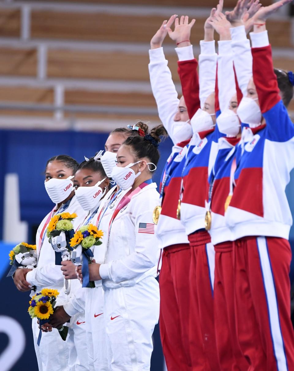 The U.S. team, left, watches the Russian Olympic Committee team celebrate its victory after the women's team final.