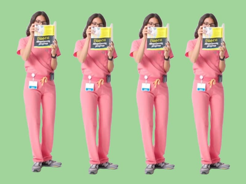 A female doctor holding a "Dummies" book upside down was used by the company Figs to promote scrubs. (Photo: Figs)