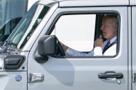 President Joe Biden drives a Jeep Wrangler 4xe Rubicon on the South Lawn of the White House in Washington, Thursday, Aug. 5, 2021, during an event on clean cars and trucks. (AP Photo/Susan Walsh)