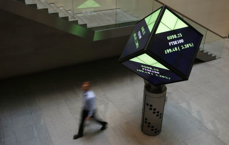 FILE PHOTO: A man walks through the lobby of the London Stock Exchange in London