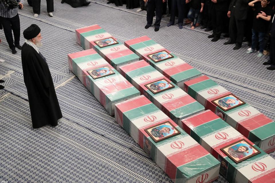 PHOTO: A handout picture provided by the office of Iran's Supreme Leader Ayatollah Ali Khamenei, April 4, 2024, shows the supreme leader praying over the coffins of seven Revolutionary Guard Corps members killed. (KHAMENEI.IR/AFP via Getty Images)