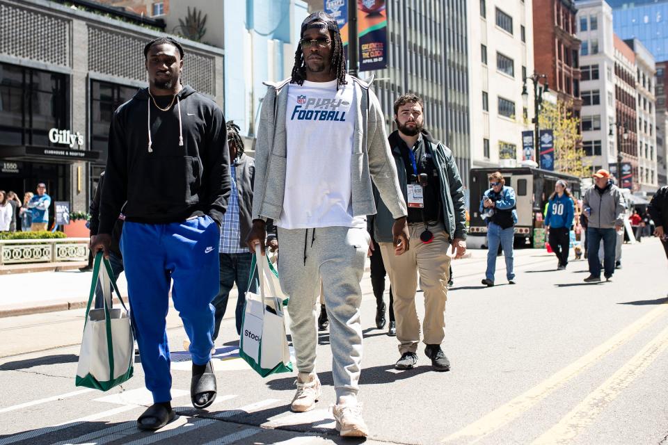Missouri defensive lineman Darius Robinson talks to his former teammate Johnny Walker as they walk on Woodward Avenue after attending a StockX event before the NFL draft in Detroit on Thursday, April 25, 2024.