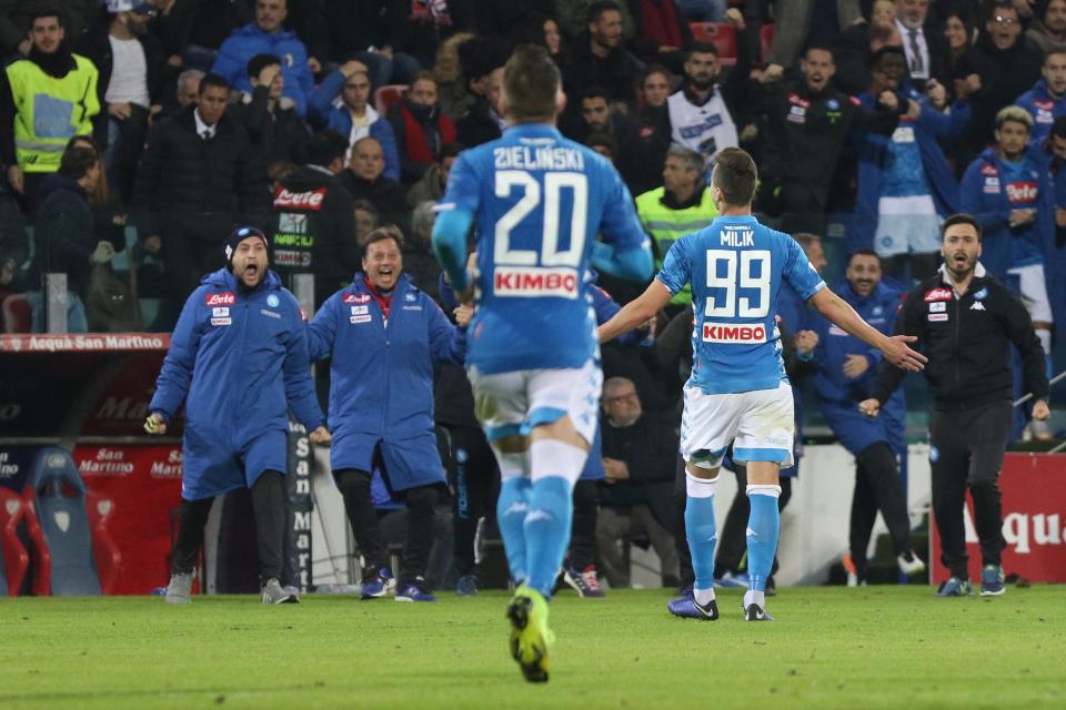 Napoli's Arkadiusz Milik, right, celebrates after scoring the winning goal during the Italian Serie A soccer match between Cagliari and Napoli at the Sardegna Arena stadium in Cagliari, Italy, Sunday, Dec. 16, 2018. (Fabio Murru/ANSA via AP)