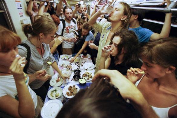 Nadezhda Tolokonnikova (bottom R) and fellow activists celebrate a wake for conceptual artist Dmitry Prigov in a Moscow metro carriage, August 24, 2007. Tolokonnikova later became a member of Pussy Riot.