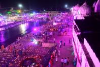 Hindu devotees gather whiel lighting earthen lamps on the banks of the River Sarayu on the eve before the groundbreaking ceremony of the proposed Ram Temple in Ayodhya on August 4, 2020. - India's Prime Minister Narendra Modi will lay the foundation stone for a grand Hindu temple in a highly anticipated ceremony at a holy site that was bitterly contested by Muslims, officials said. The Supreme Court ruled in November 2019 that a temple could be built in Ayodhya, where Hindu zealots demolished a 460-year-old mosque in 1992. (Photo by SANJAY KANOJIA / AFP) (Photo by SANJAY KANOJIA/AFP via Getty Images)