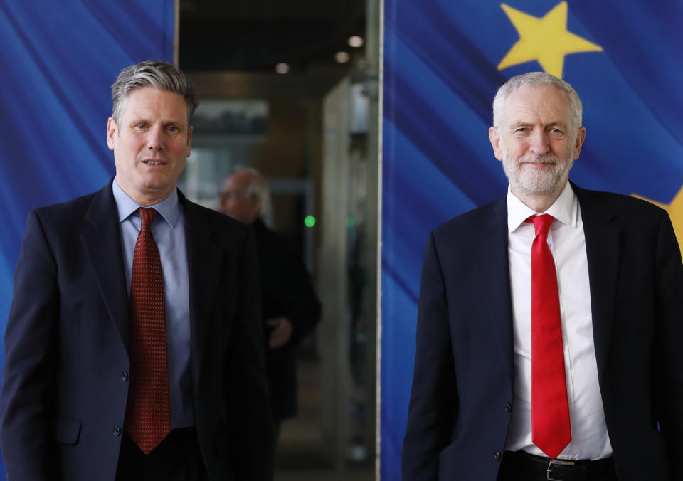British Labour Party leader Jeremy Corbyn, right, and Keir Starmer, Labour Shadow Brexit secretary, leave EU headquarters prior to an EU summit in Brussels, Thursday, March 21, 2019. British Prime Minister Theresa May is trying to persuade European Union leaders to delay Brexit by up to three months, just eight days before Britain is scheduled to leave the bloc. (AP Photo/Frank Augstein)