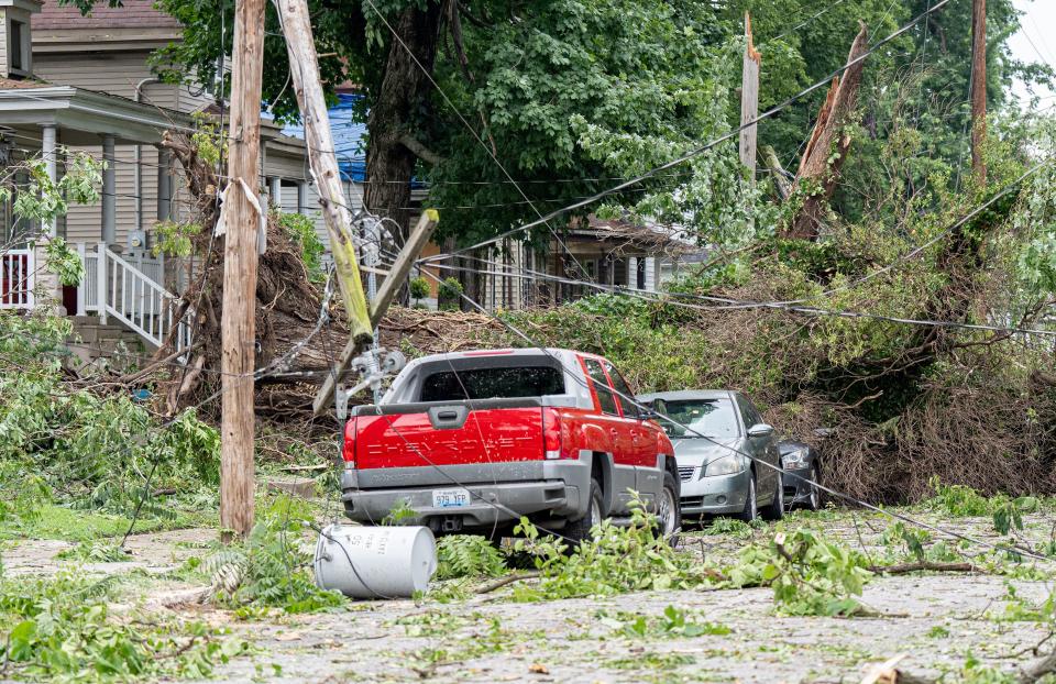 Power lines were down after an EF1 tornado damaged houses and uprooted trees on Olive Street near Woodland Avenue in Louisville’s West End on Thursday, July 4, 2024.