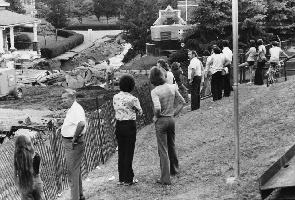 Akron residents survey the damage June 23, 1977, at the main entrance to Glendale Cemetery.