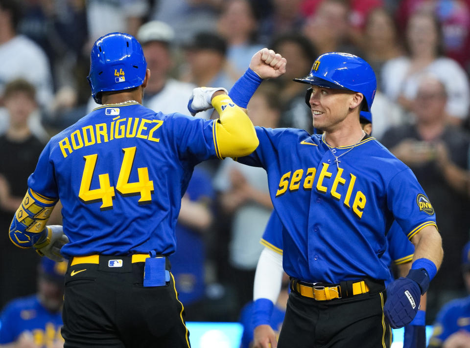 Seattle Mariners' Julio Rodríguez (44) is greeted by Cade Marlowe, right, who scored on his three-run home run against the Baltimore Orioles during the fourth inning of a baseball game Friday, Aug. 11, 2023, in Seattle. (AP Photo/Lindsey Wasson)