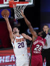 Phoenix Suns' Dario Saric (20) shoots over Miami Heat's Andre Iguodala (28) during the first half of an NBA basketball game, Saturday, Aug. 8, 2020 in Lake Buena Vista, Fla. (AP Photo/Ashley Landis, Pool)