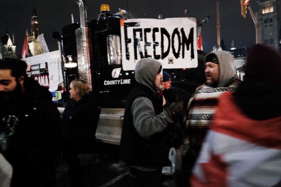 Truck drivers and their supporters gather to block the streets as part of a convoy of truck protesters against COVID-19 mandates on Feb. 9, 2022, in Ottawa, Ontario.