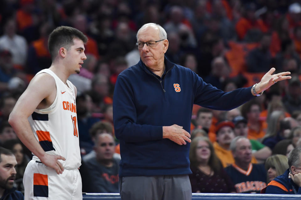 Syracuse head coach Jim Boeheim, right, talks with guard Joseph Girard III during the first half of an NCAA college basketball game against North Carolina State in Syracuse, N.Y., Tuesday, Feb. 14, 2023. (AP Photo/Adrian Kraus)